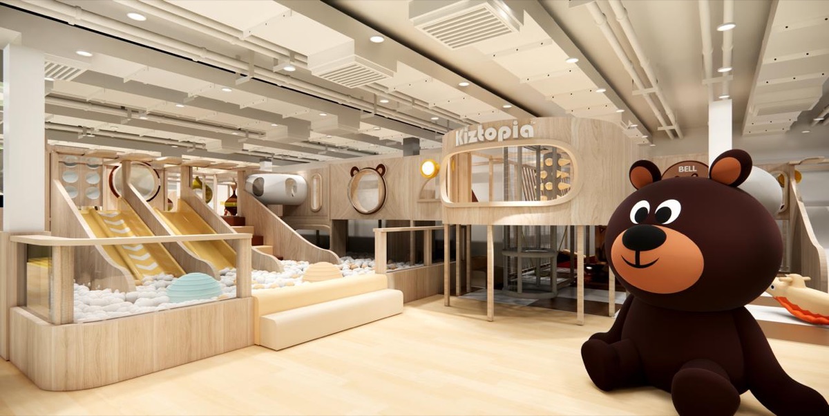 The Kiztopia Prestige play space at New Bahru, with timber slides, a soft play pit and a giant bear